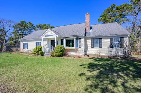 a front view of a house with a yard