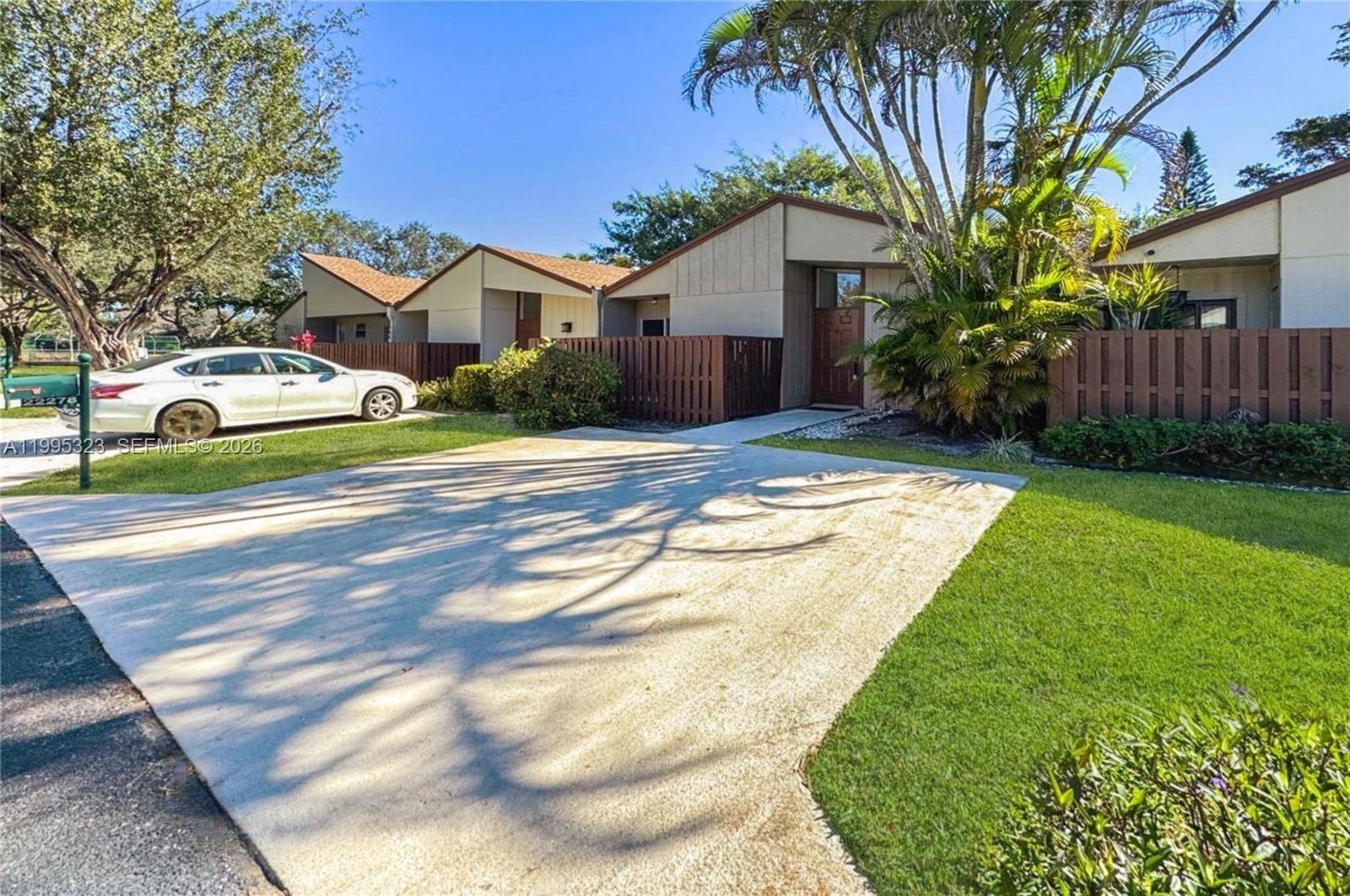 22278 Misty Woods Way, Unit 22278 Boca Raton, FL 33428 - Photo 1 of 20 a front view of a house with garden