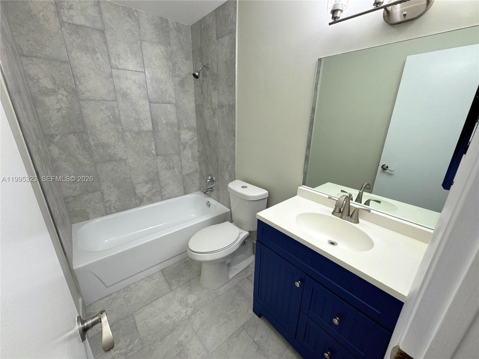 22278 Misty Woods Way, Unit 22278 Boca Raton, FL 33428 - Photo 11 of 20 a bathroom with a sink a toilet and bathtub