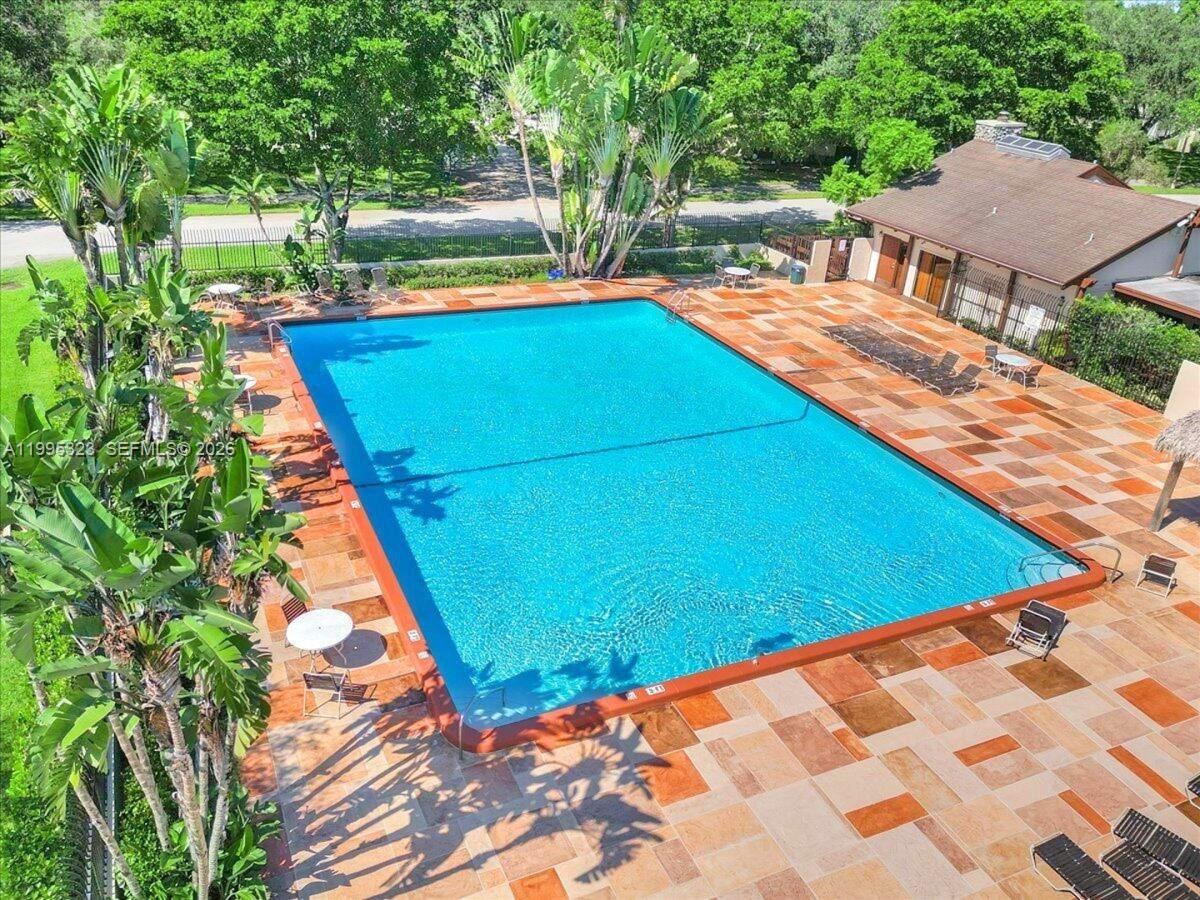 22278 Misty Woods Way, Unit 22278 Boca Raton, FL 33428 - Photo 18 of 20 a view of an outdoor space and swimming pool
