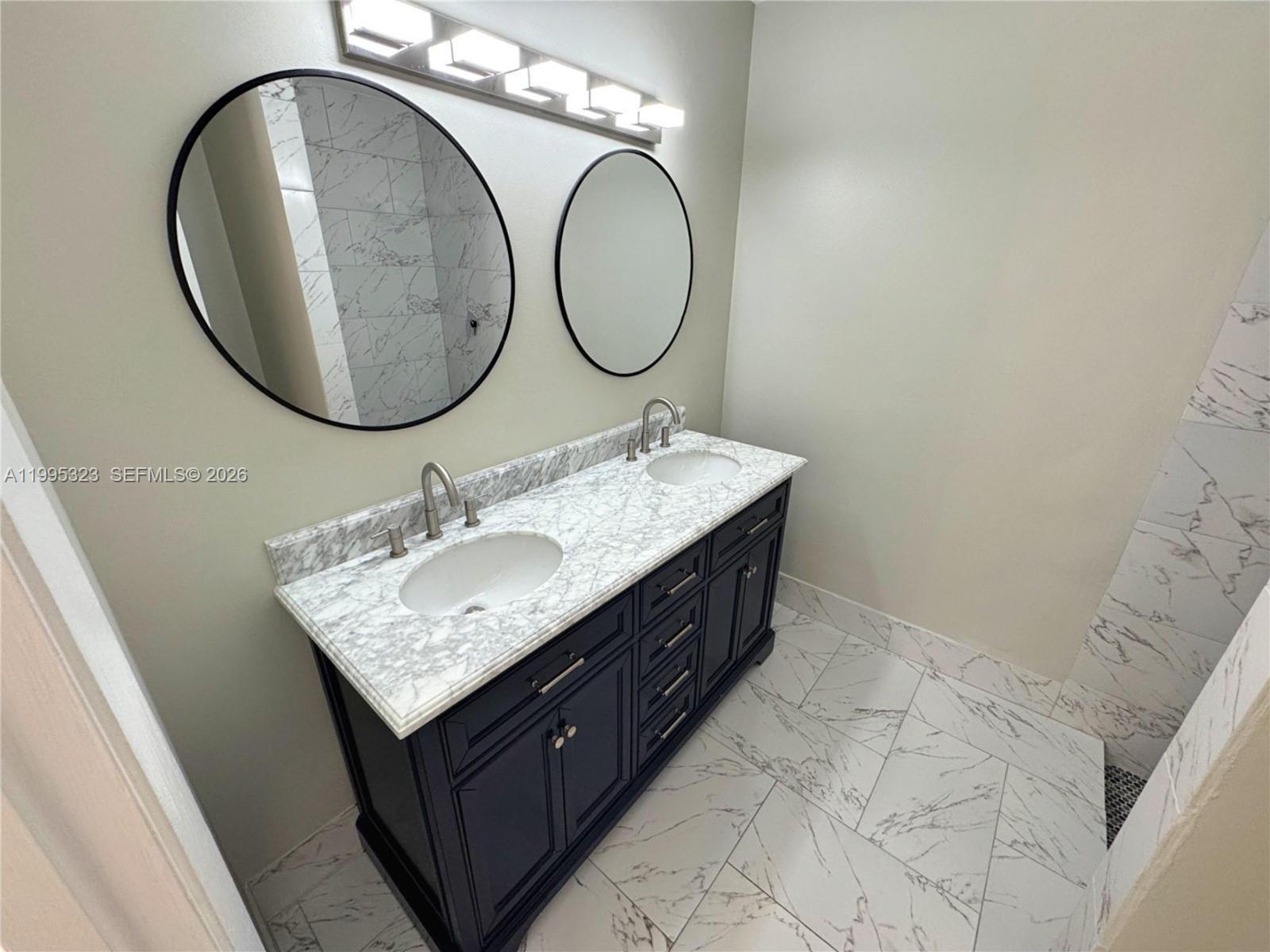 22278 Misty Woods Way, Unit 22278 Boca Raton, FL 33428 - Photo 10 of 20 a bathroom with a granite countertop double vanity and a mirror