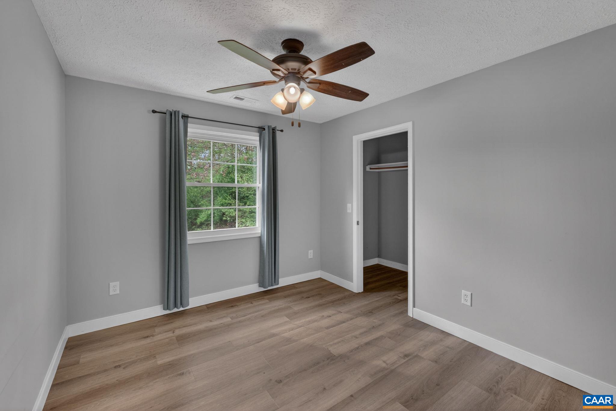 673 Cedar Lane Road Palmyra, VA 22963 - Photo 30 of 47 a view of an empty room with a ceiling fan and a window