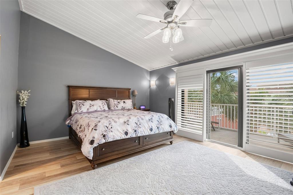 529 Sandy Hook Road Treasure Island, FL 33706 - Photo 24 of 55 a bedroom with a large bed and a chandelier fan