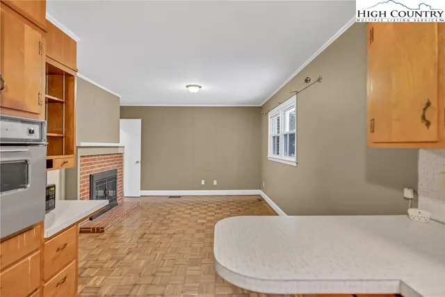 a view of room with window and wooden floor