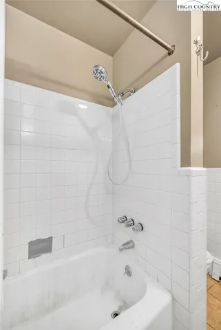 a view of an empty room with a kitchen