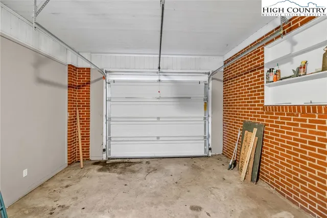 a kitchen with stainless steel appliances a refrigerator a sink a stove top oven a counter space and cabinets