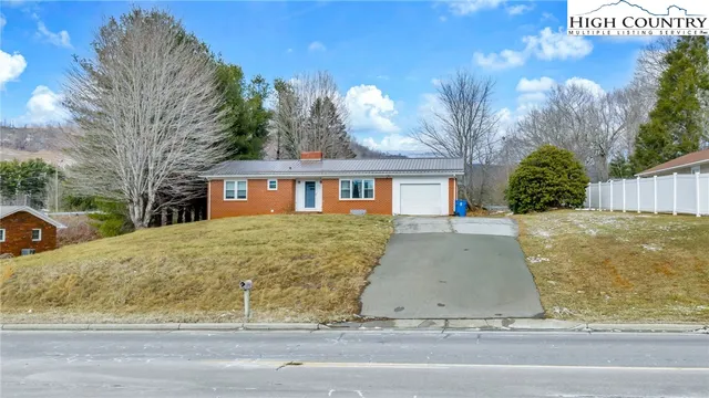 an empty room with wooden floor and door