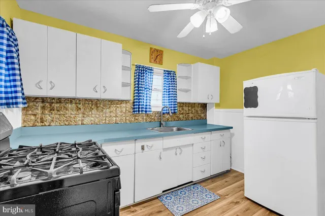 a kitchen with granite countertop a sink stainless steel appliances and cabinets