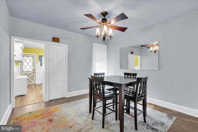 a view of a dining room with furniture and chandelier