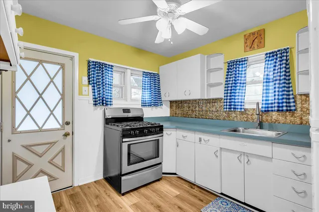 a kitchen with stainless steel appliances granite countertop a stove and a sink
