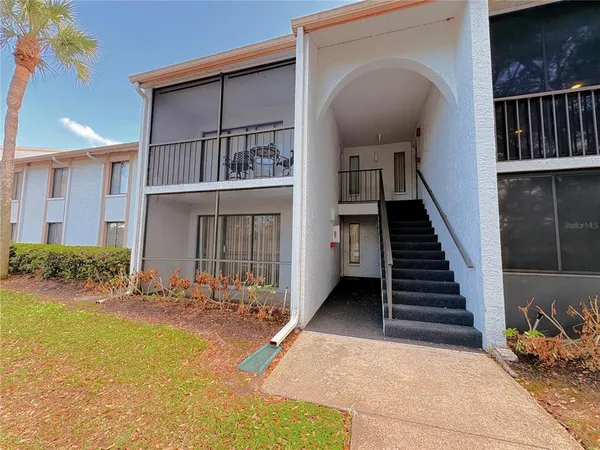 a view of a house with more windows and a small yard
