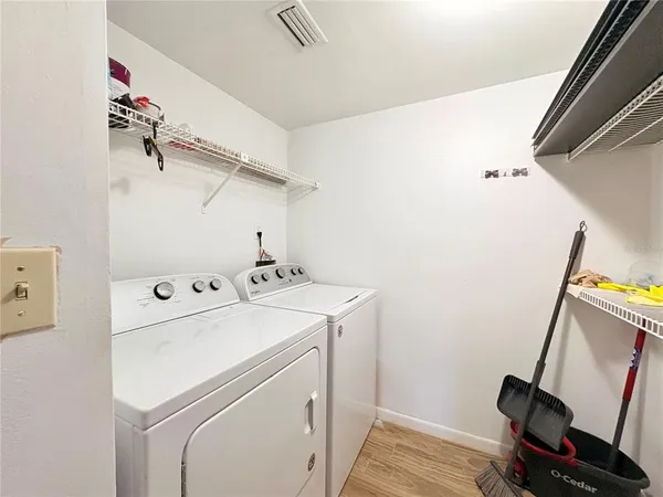 a view of storage and utility room with washer and dryer