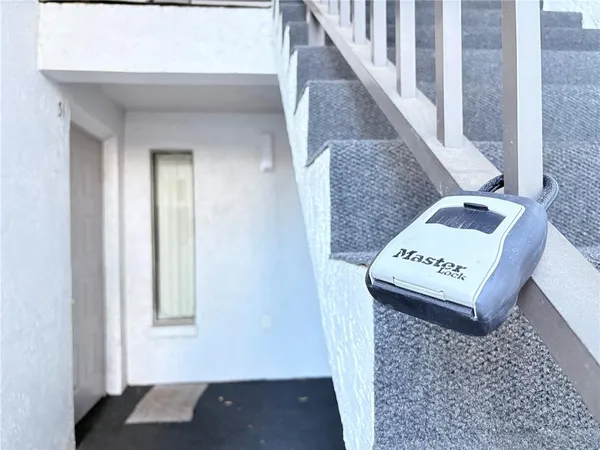 a view of a swimming pool with a yard and a chair