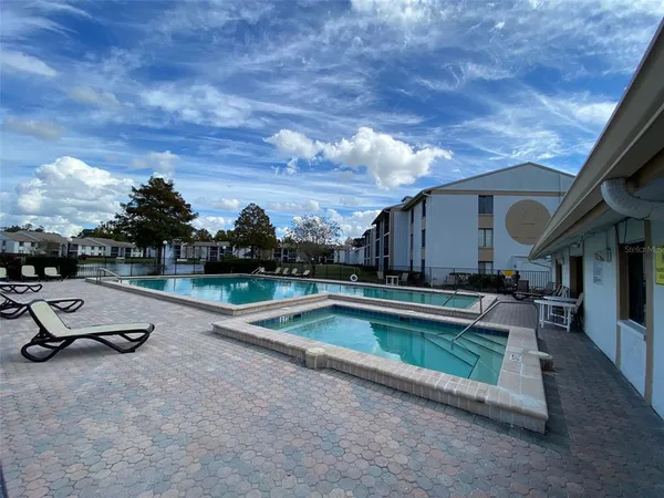 an outdoor view of house with backyard and pool