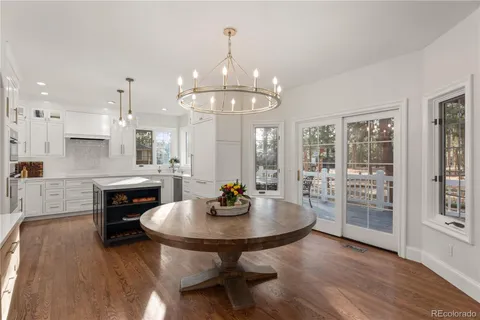 a living room with furniture a fireplace and a floor to ceiling window
