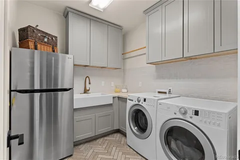 a spacious bedroom with a bed and a chandelier