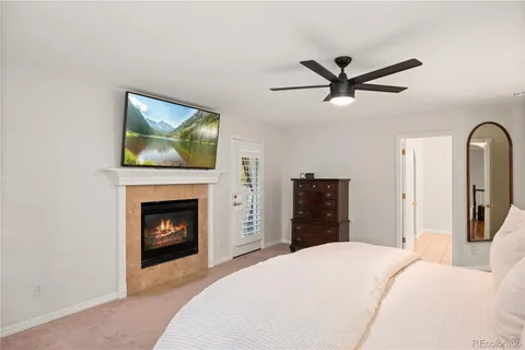 a bed sitting in a bedroom next to a window with a chandelier