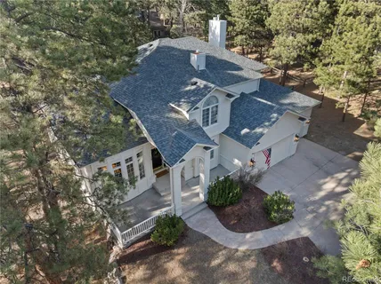 an aerial view of a house with a yard