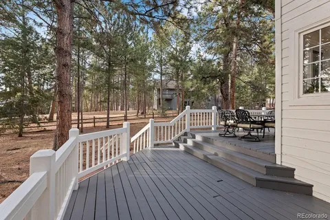 a view of a deck with chairs and wooden floor