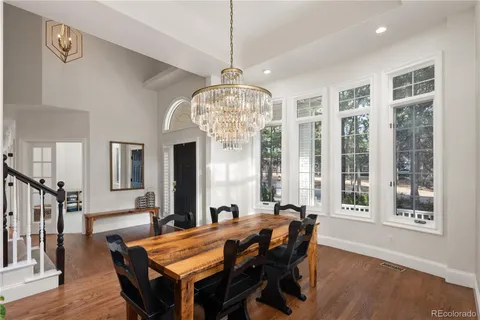 a view of a dining room with furniture and chandelier