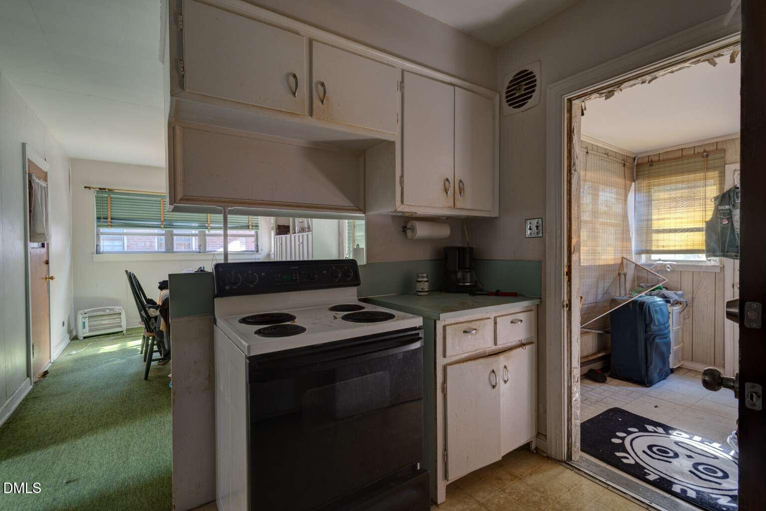 128 Nelson Street Durham, NC 27707 - Photo 11 of 23 a kitchen with a stove a sink and a refrigerator