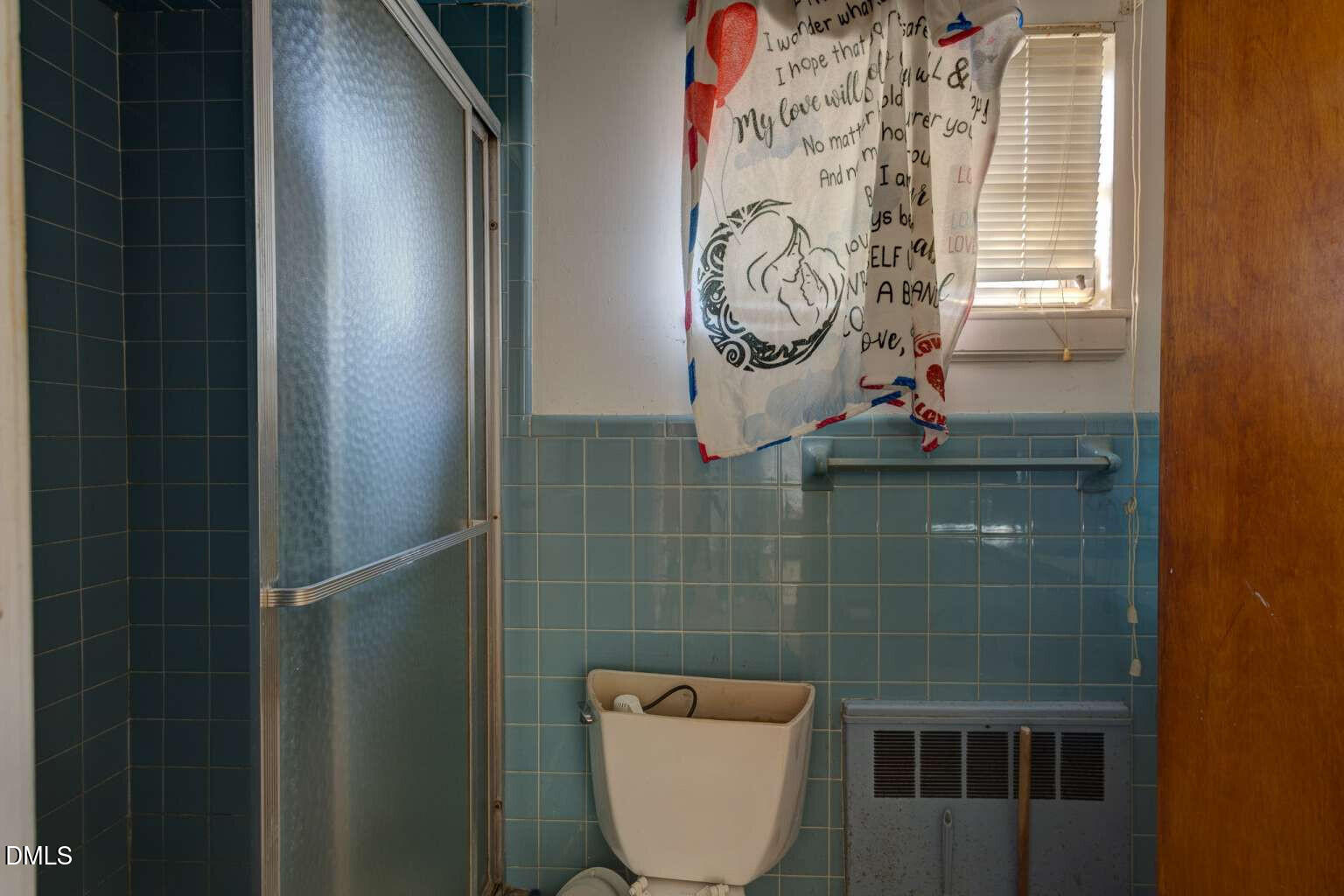 128 Nelson Street Durham, NC 27707 - Photo 18 of 23 a bathroom with a toilet and a shower curtain