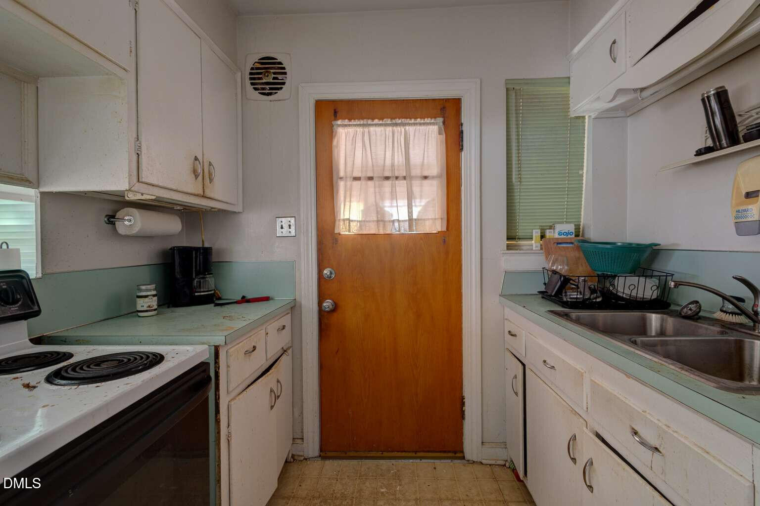 128 Nelson Street Durham, NC 27707 - Photo 9 of 23 a kitchen with stainless steel appliances granite countertop a sink stove and cabinets