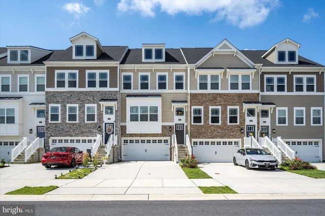a front view of a house with a garden and barbeque oven