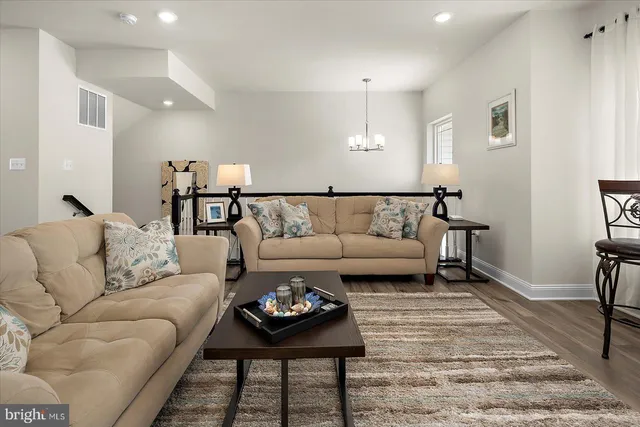 a kitchen with a dining table chairs appliances wooden floor and cabinets