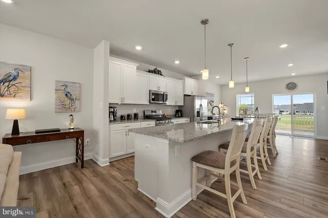 a view of a dining room with furniture and a window