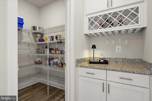 a bathroom with a granite countertop sink a mirror and shower