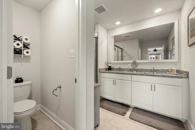 a bedroom with two beds and a chandelier