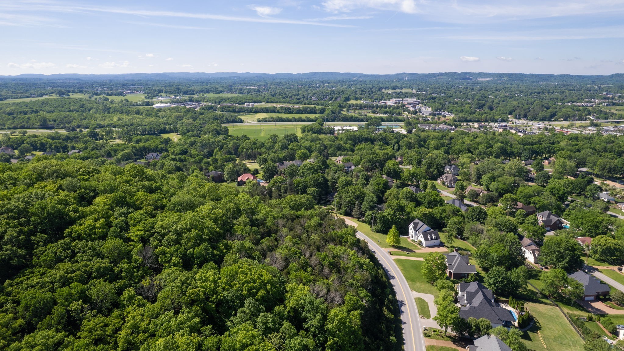 242 Spencer Creek Road Franklin, TN 37069 - Photo 13 of 16 a view of a city with lush green forest