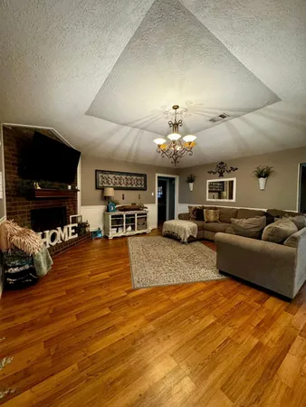a living room with furniture and a chandelier