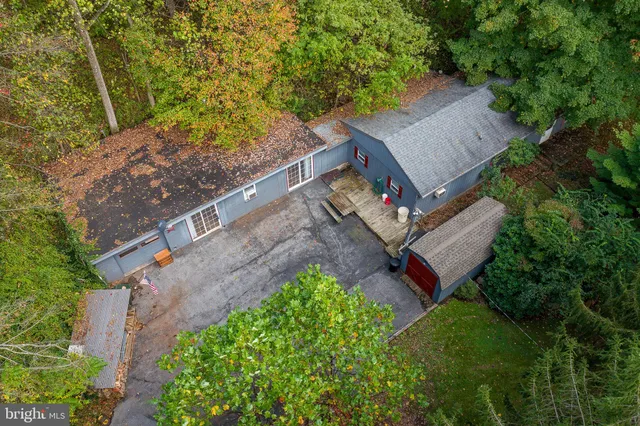 an aerial view of a house with a yard basket ball court and outdoor seating