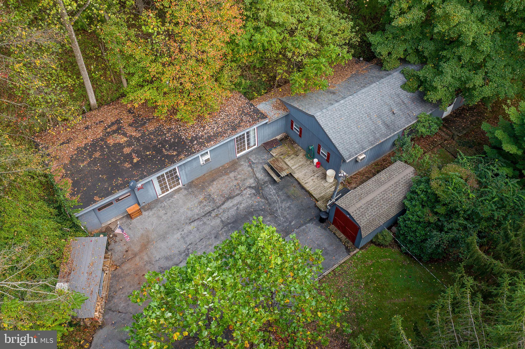 an aerial view of a house with a yard basket ball court and outdoor seating
