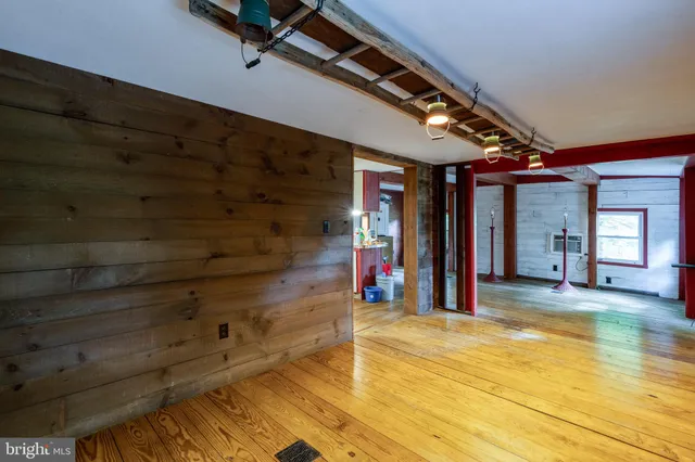 a kitchen with a sink cabinets and wooden floor