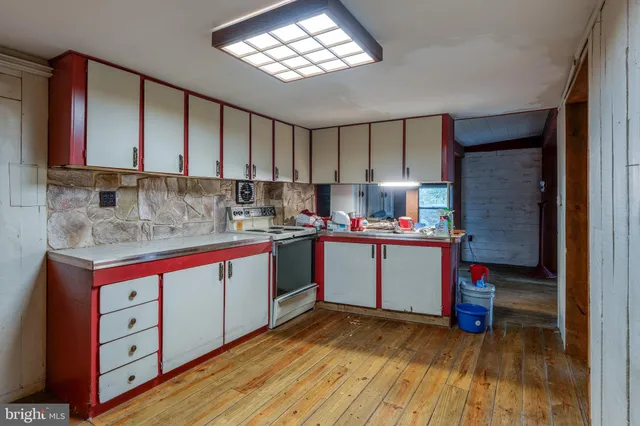 a kitchen view of a dining table chairs and a stove
