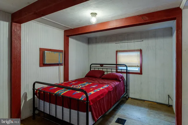 a bedroom with a bed and a mirror