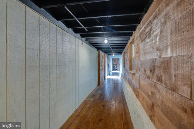 a open kitchen with granite countertop a stove and a wooden floor