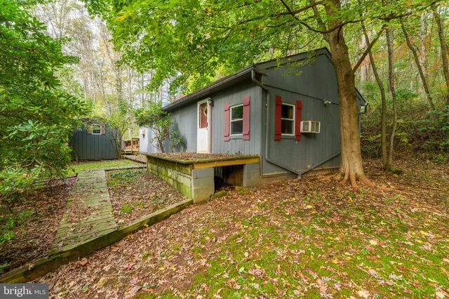 a view of a patio with table and chairs with wooden fence and floor