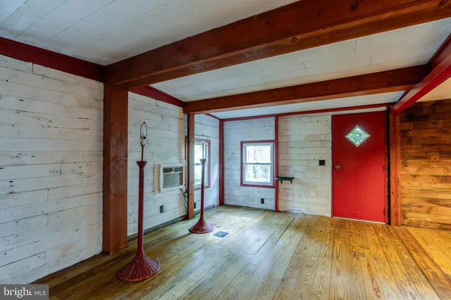 a view of a room with wooden floor and windows