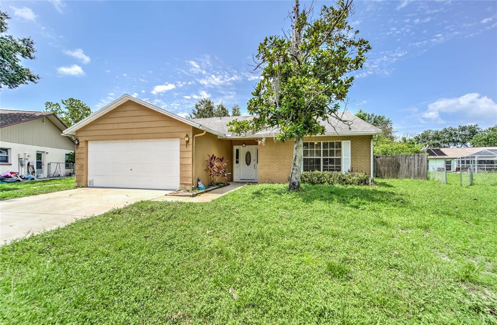 7964 Putnam Circle New Port Richey, FL 34655 - Photo 1 of 1 a front view of a house with a yard and garage