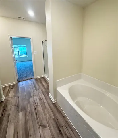 a bathroom with a bathtub and a shower