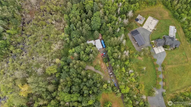 a view of a house with a patio and backyard