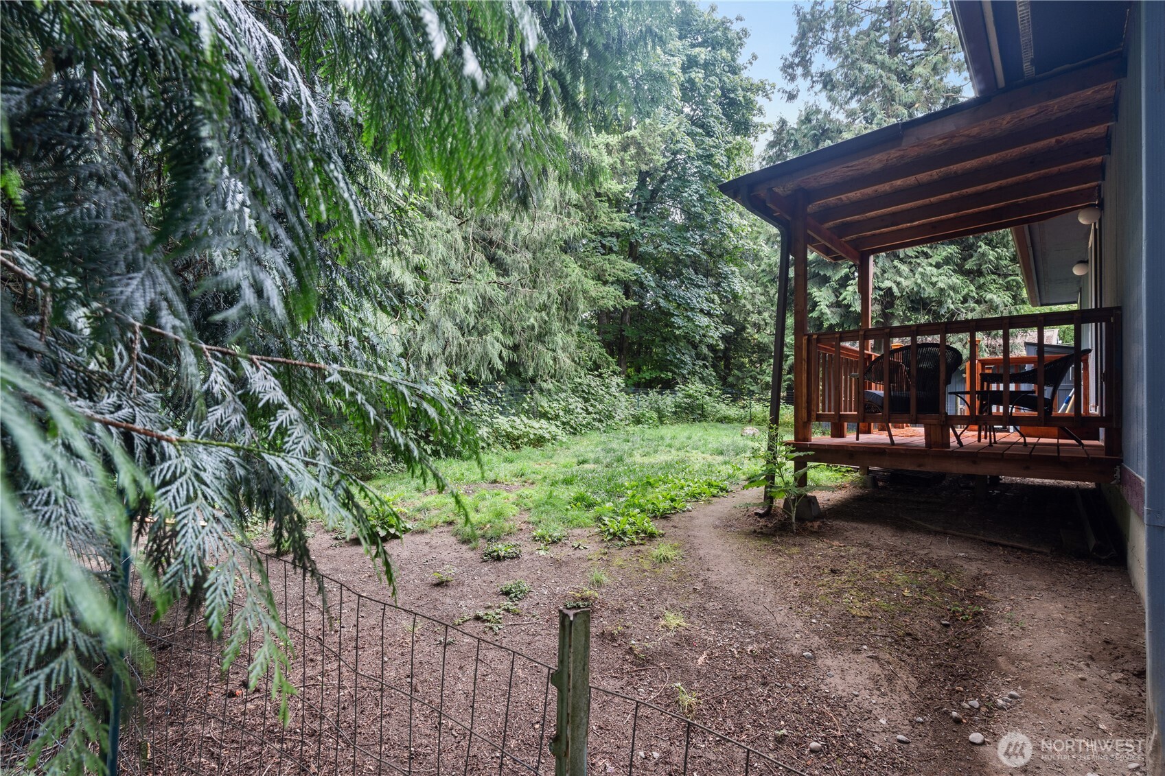 5818 Everson Goshen Road Bellingham, WA 98226 - Photo 28 of 34 a view of a backyard with large trees and wooden fence