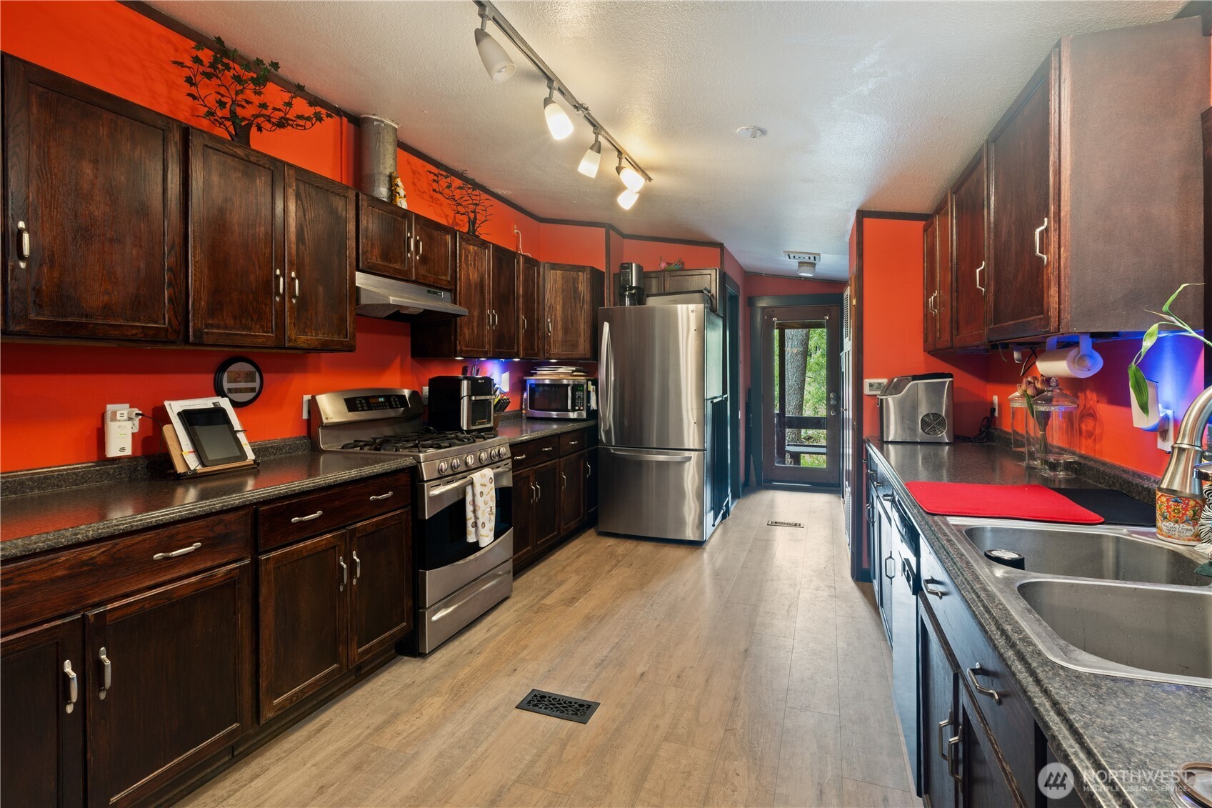5818 Everson Goshen Road Bellingham, WA 98226 - Photo 3 of 34 a kitchen with stainless steel appliances kitchen island granite countertop a stove a sink and a refrigerator
