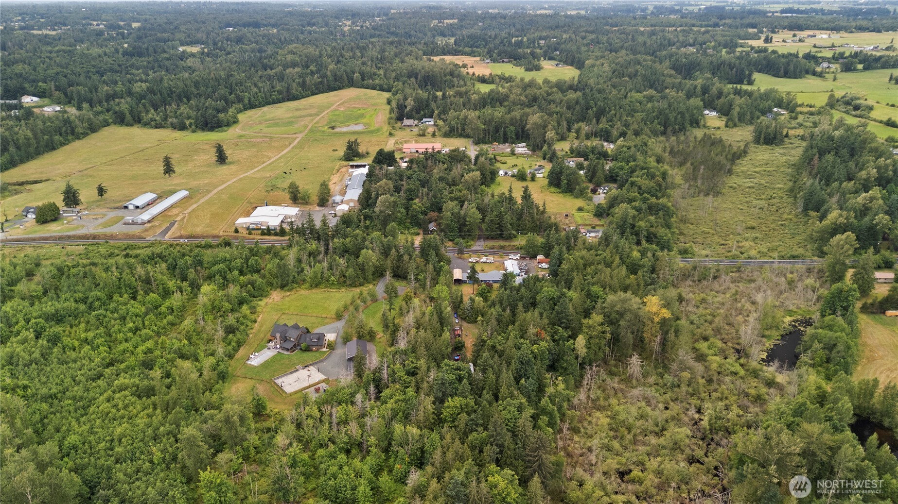 5818 Everson Goshen Road Bellingham, WA 98226 - Photo 31 of 34 an aerial view of a house with a yard and lake view