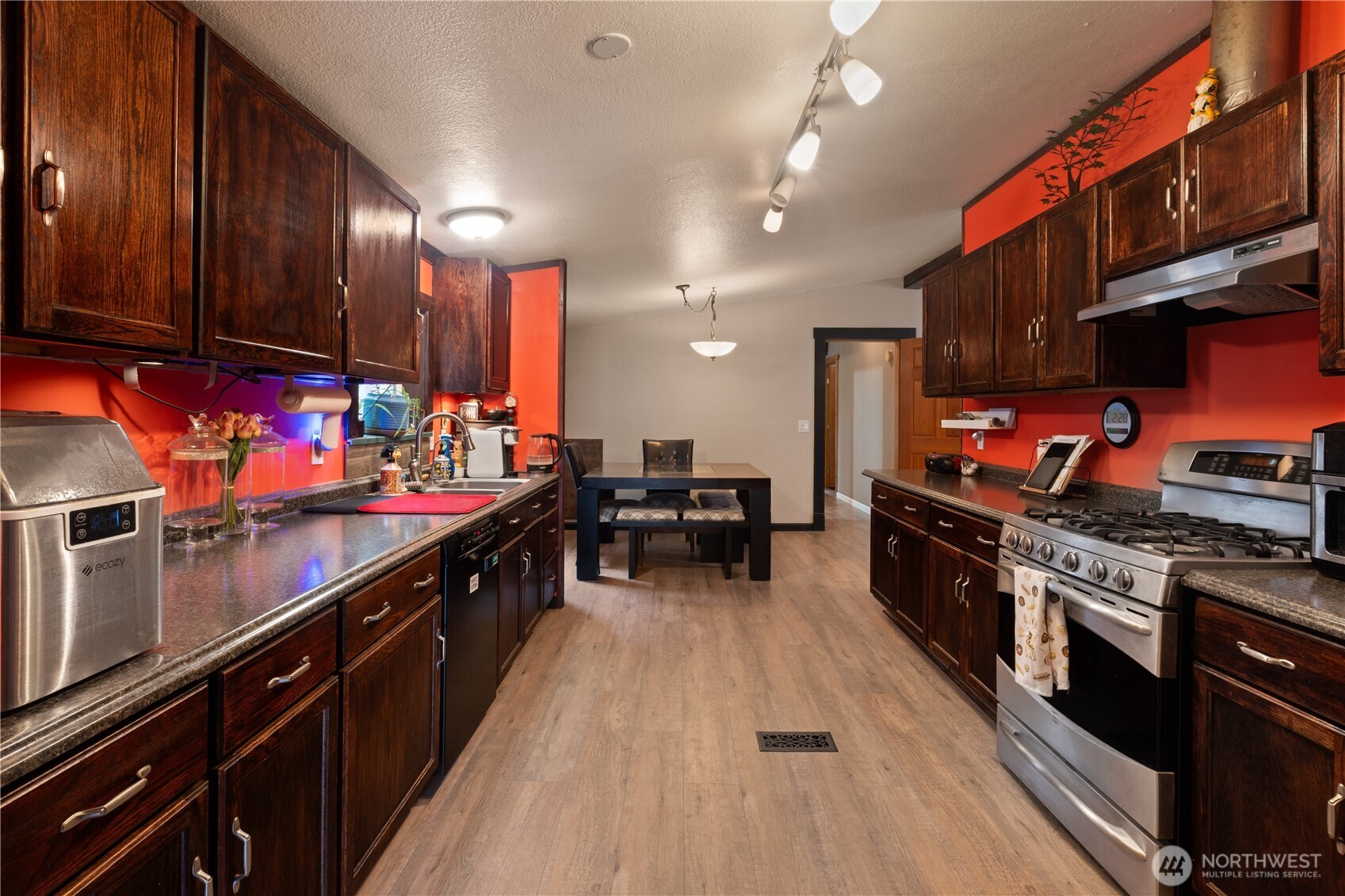 5818 Everson Goshen Road Bellingham, WA 98226 - Photo 5 of 34 a kitchen with stainless steel appliances kitchen island granite countertop a stove a sink dishwasher and cabinets with wooden floor