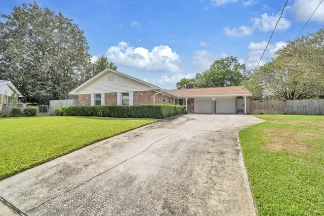 a front view of house with yard and green space